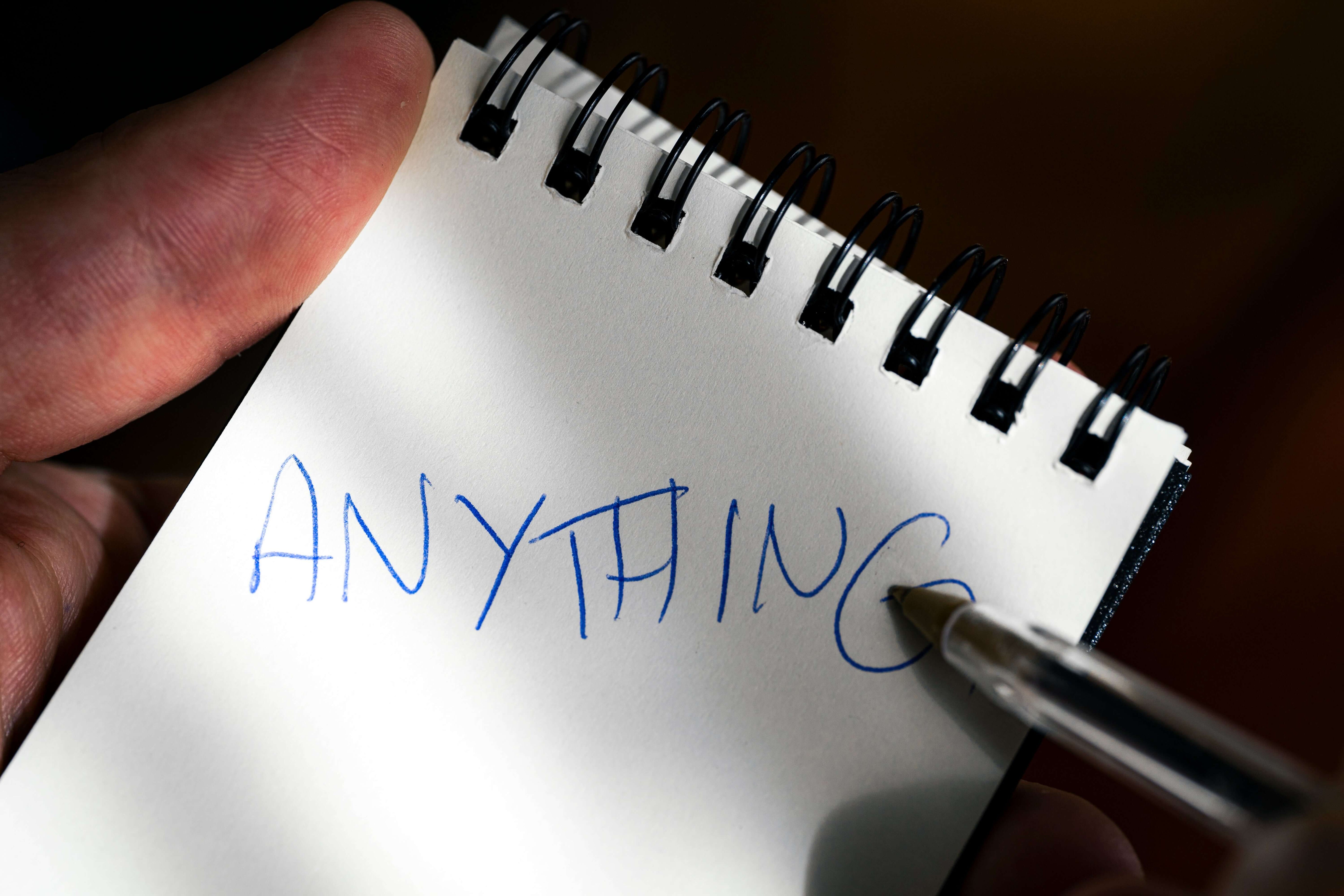 REPLICA: Pocket-size Impression Pad showcasing handwriting that says 'ANYTHING'. Perfect for magic tricks!