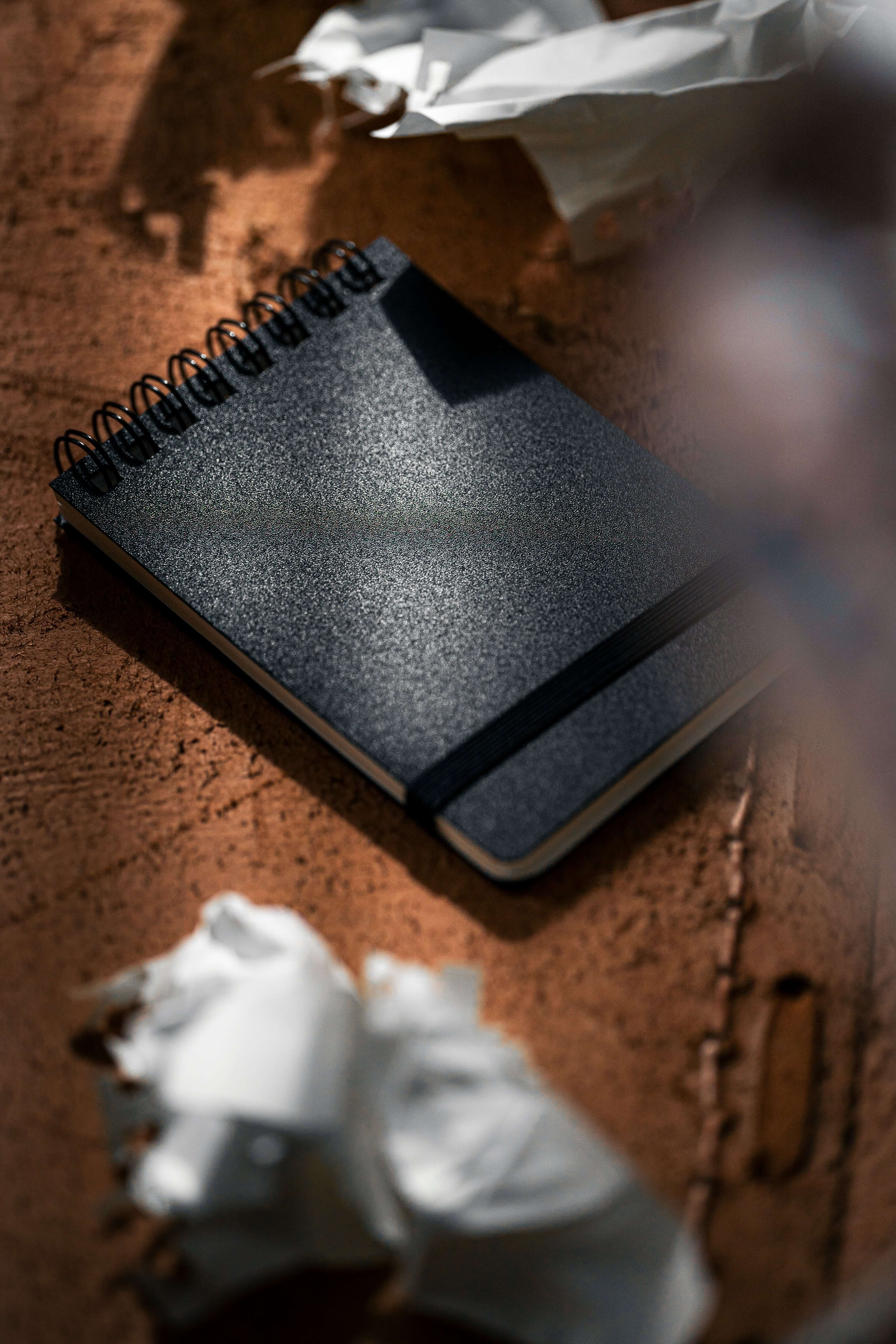 REPLICA: Pocket-size Impression Pad on a textured surface with crumpled paper.